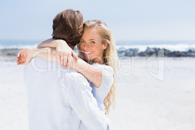 Cute couple hugging on the beach