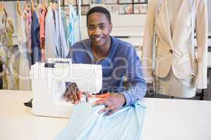 Smiling university student using sawing machine