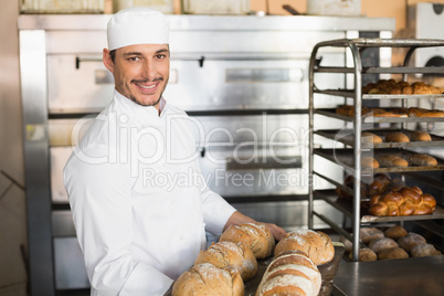 Happy baker showing tray of fresh bread