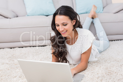 Pretty brunette using her laptop