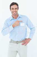 Confident businessman pointing over white background