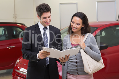 Salesman showing brochure to customer and smiling