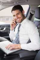 Businessman working in the drivers seat