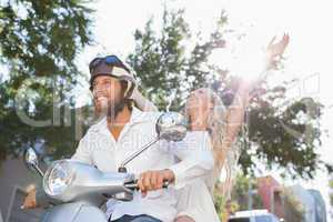 Cute couple riding a scooter