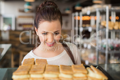 Pretty brunette looking at pastrys