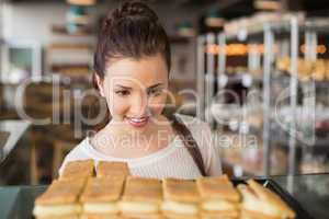 Pretty brunette looking at pastrys