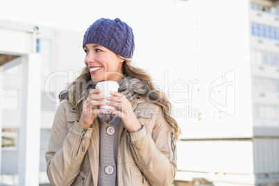 Pretty blonde holding take-away cup