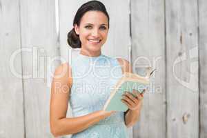 Stylish brunette reading a book