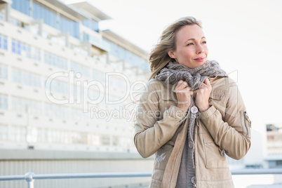 Cold blonde standing and thinking