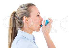 Pretty blonde using an asthma inhaler