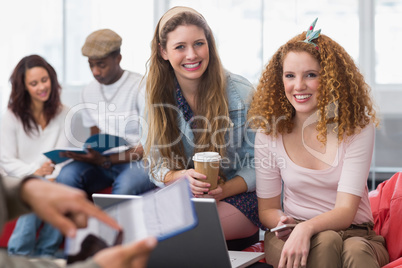 Fashion students smiling at camera together