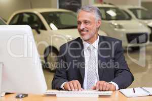 Cheerful businessman working at his desk