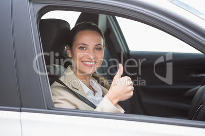 Smiling businesswoman giving thumbs up