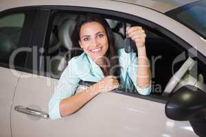 Smiling woman holding car key