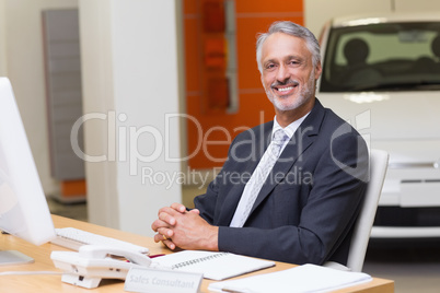 Happy businessman working at his desk