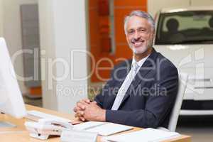 Happy businessman working at his desk