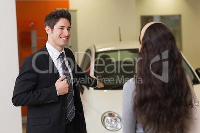 Businessman showing a car to a woman Businessman showing a car to a woman
