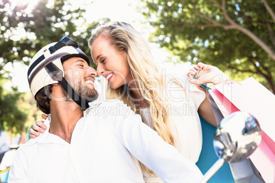 Attractive couple riding a scooter