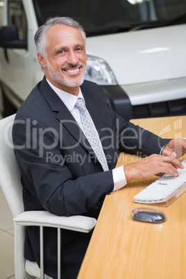 Cheerful businessman working at his desk