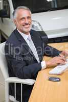 Cheerful businessman working at his desk