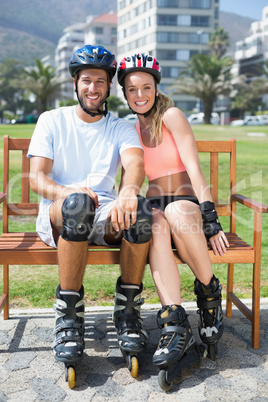 Fit couple getting ready to roller blade