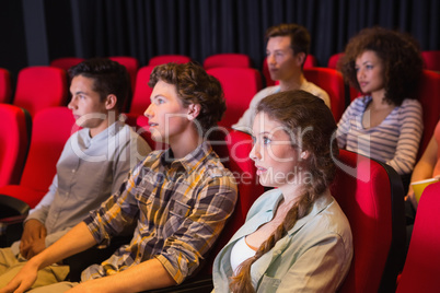 Young friends watching a film