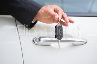 Close up of businessman holding car key