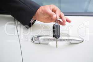 Close up of businessman holding car key