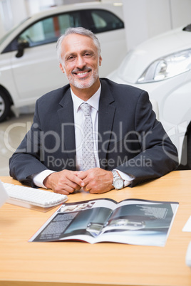 Happy businessman working at his desk