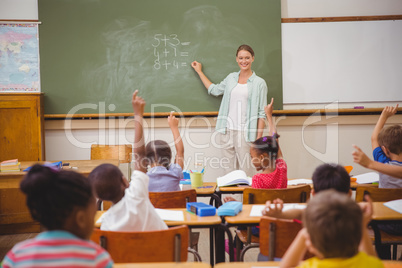 Pupils raising their hands during class