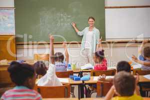 Pupils raising their hands during class