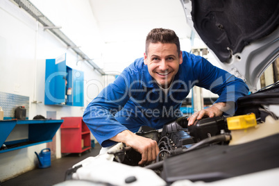 Mechanic working under the hood