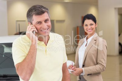 Smiling customer calling with his mobile phone Smiling customer calling with his mobile phone