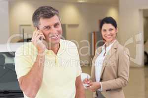 Smiling customer calling with his mobile phone