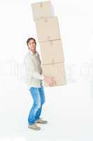 Portrait of courier man balancing cardboard boxes