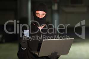 Hacker using laptop to steal identity