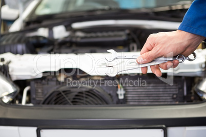 Mechanic standing with wrench in hand