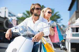 Attractive couple riding a scooter