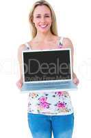 Smiling blonde presenting her laptop