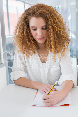 Student taking notes in class