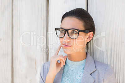 Stylish brunette thinking and smiling