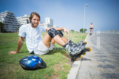 Fit man getting ready to roller blade