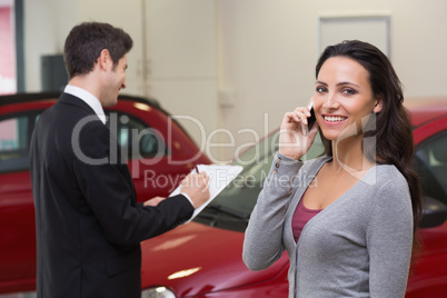 Smiling woman calling someone with her mobile phone