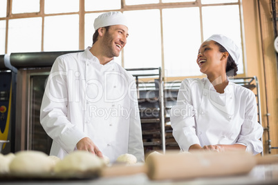 Team of bakers preparing dough