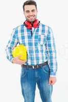 Confident manual worker with hardhat and ear muffs