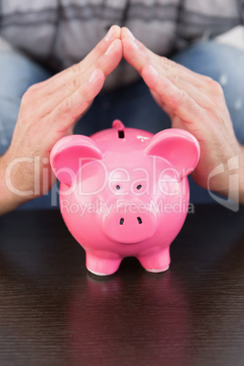 Smiling man with piggy bank