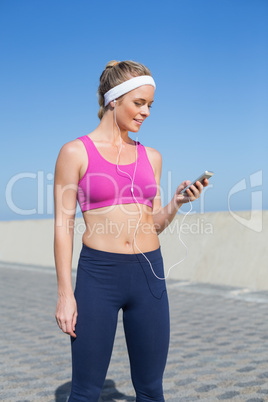 Fit blonde standing on the promenade