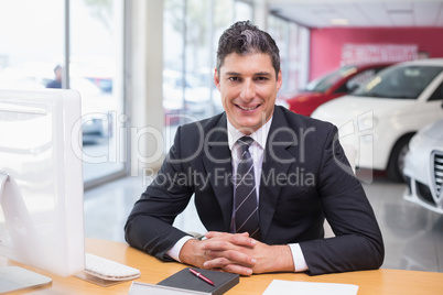 Happy businessman working at his desk