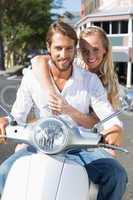 Attractive couple riding a scooter