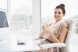 Relaxed businesswoman holding hot drink